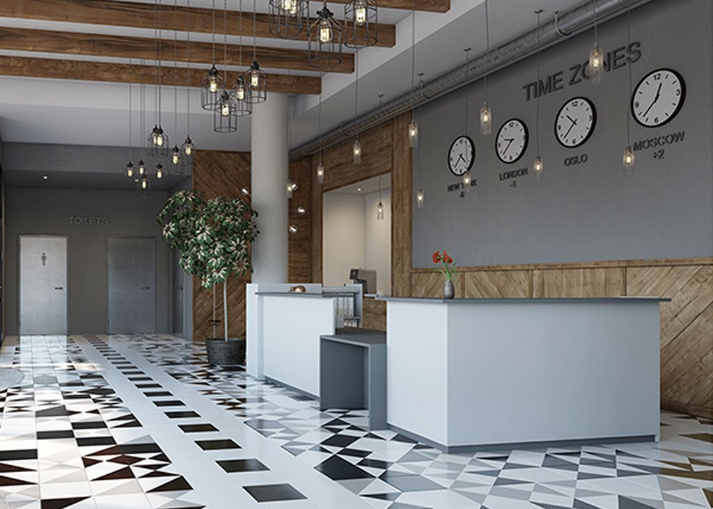 Lobby med hvite resepsjonsskranker, rutete gulv, tredetaljer og en tidssoneskjerm.