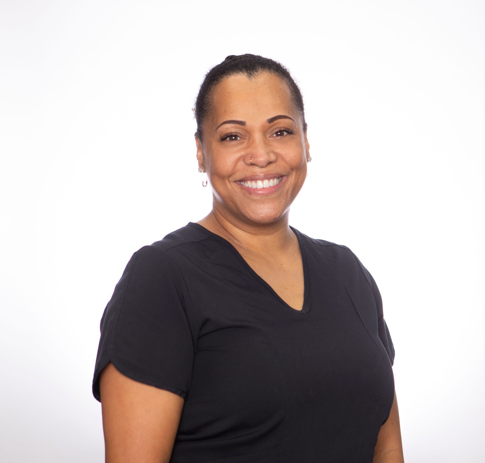 A woman in a black shirt is smiling for the camera.