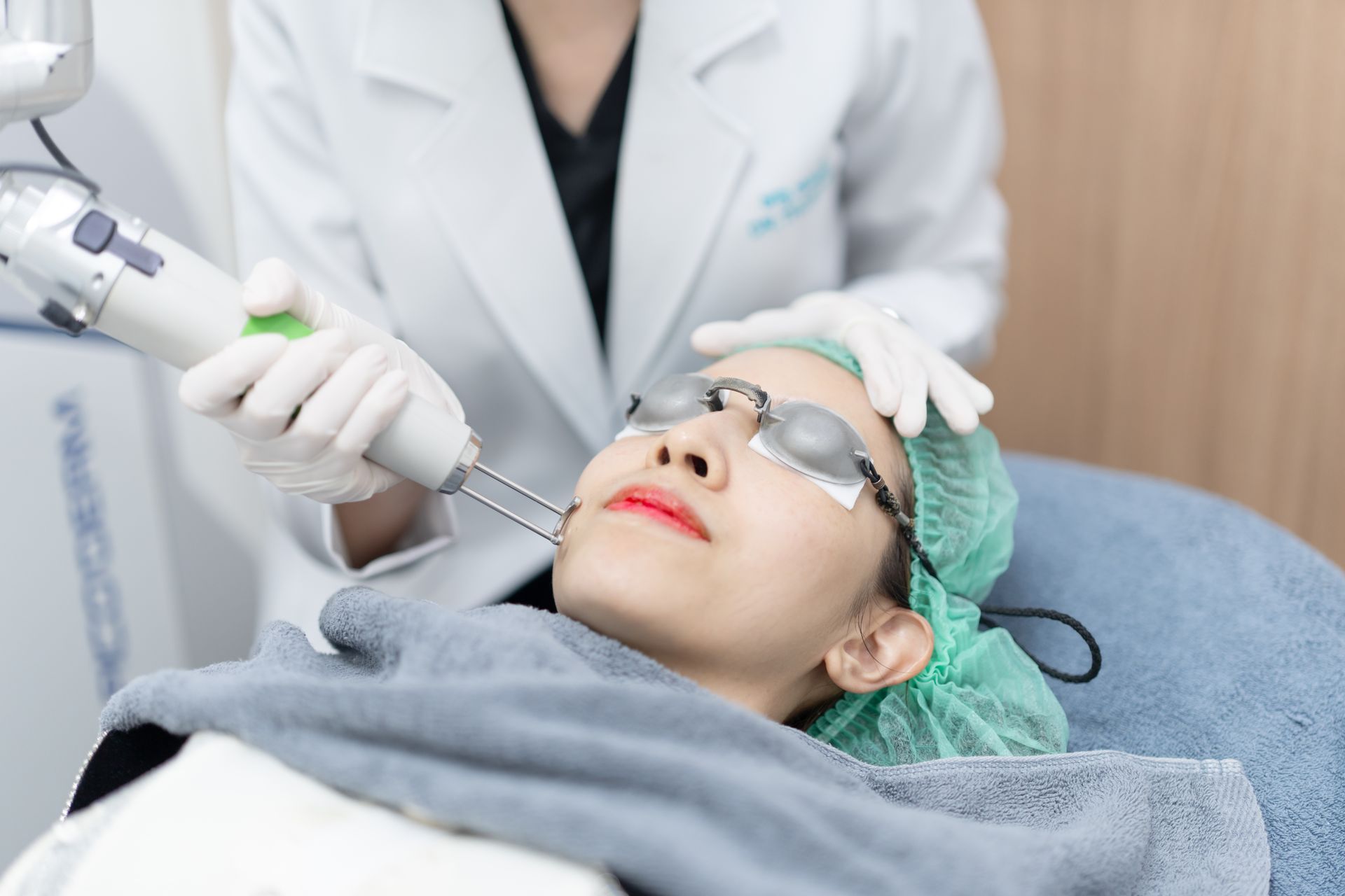 a woman getting laser treatment on her face