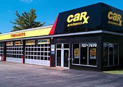 CarX Auto Service building exterior. Yellow and black sign, garage bays, and glass windows.