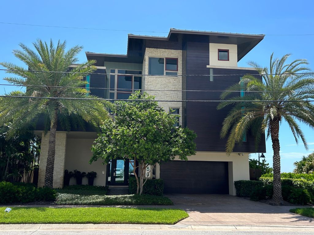 A large house with palm trees in front of it