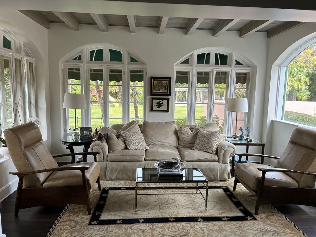 A living room with a couch and two chairs