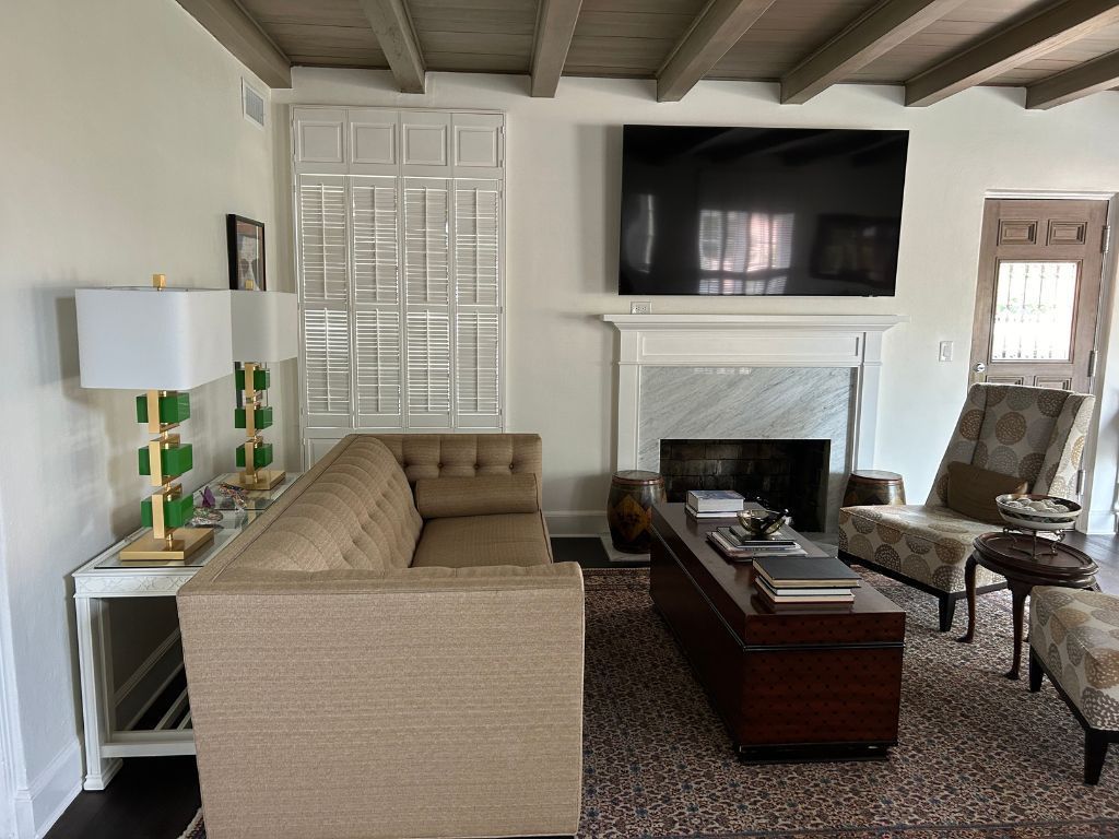 A living room with a couch a fireplace and a flat screen tv