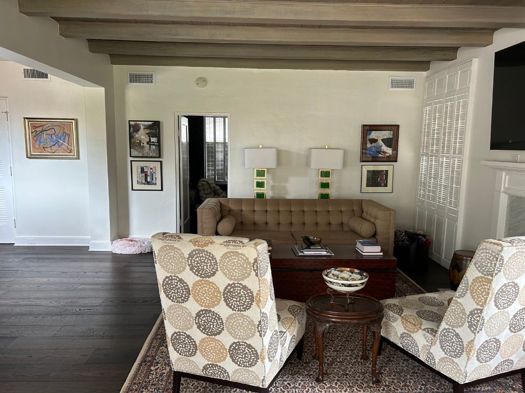 A living room with a couch , chairs , coffee table and fireplace.