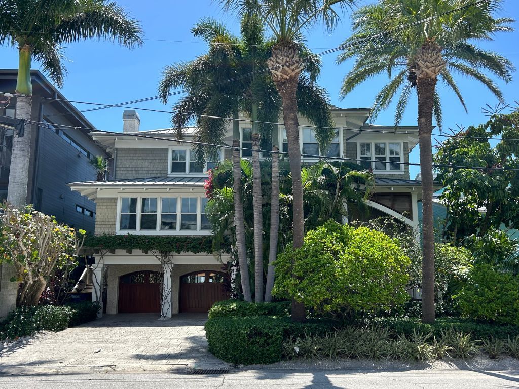 A large house with palm trees in front of it