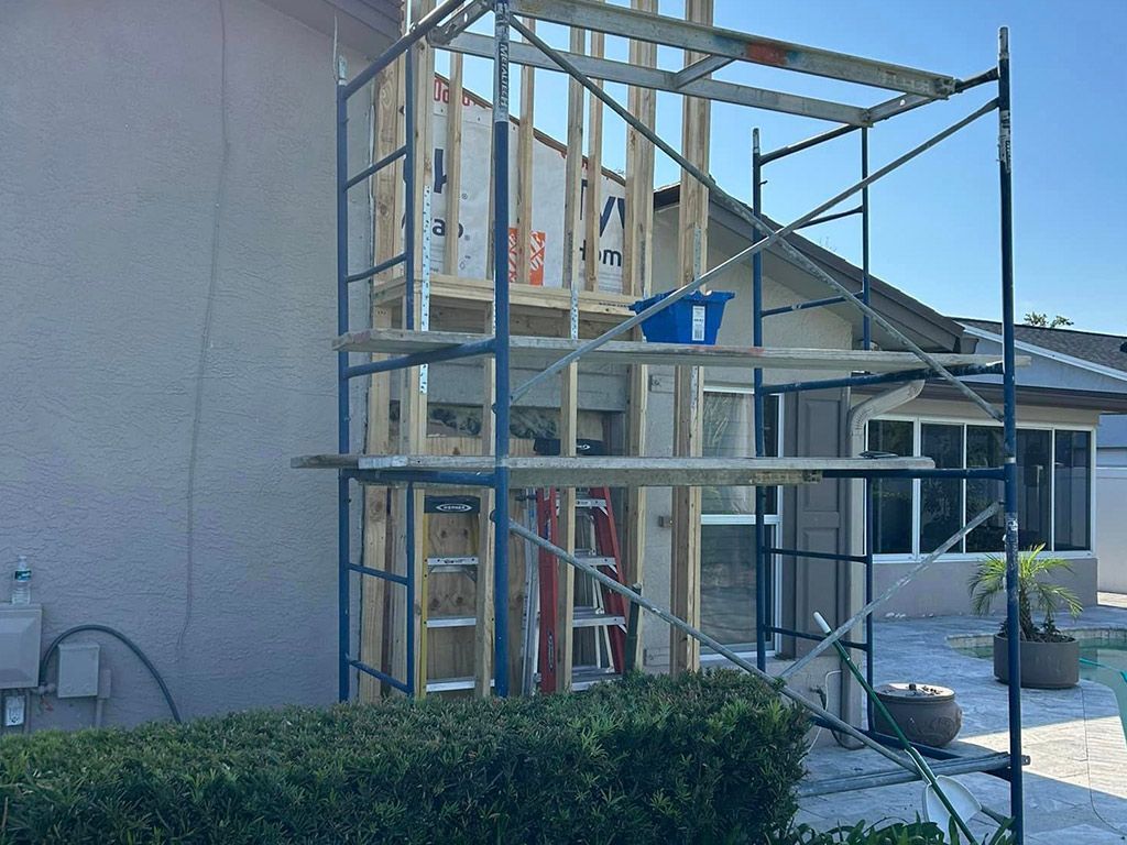 A house is being built with a scaffolding around it.