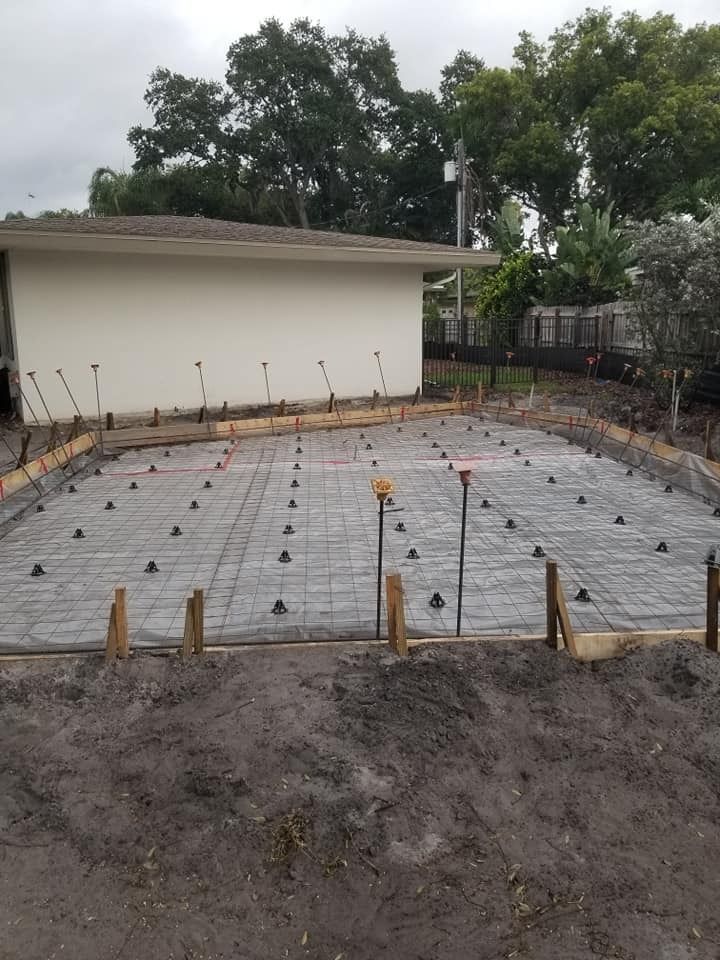 A concrete base is being built in front of a building