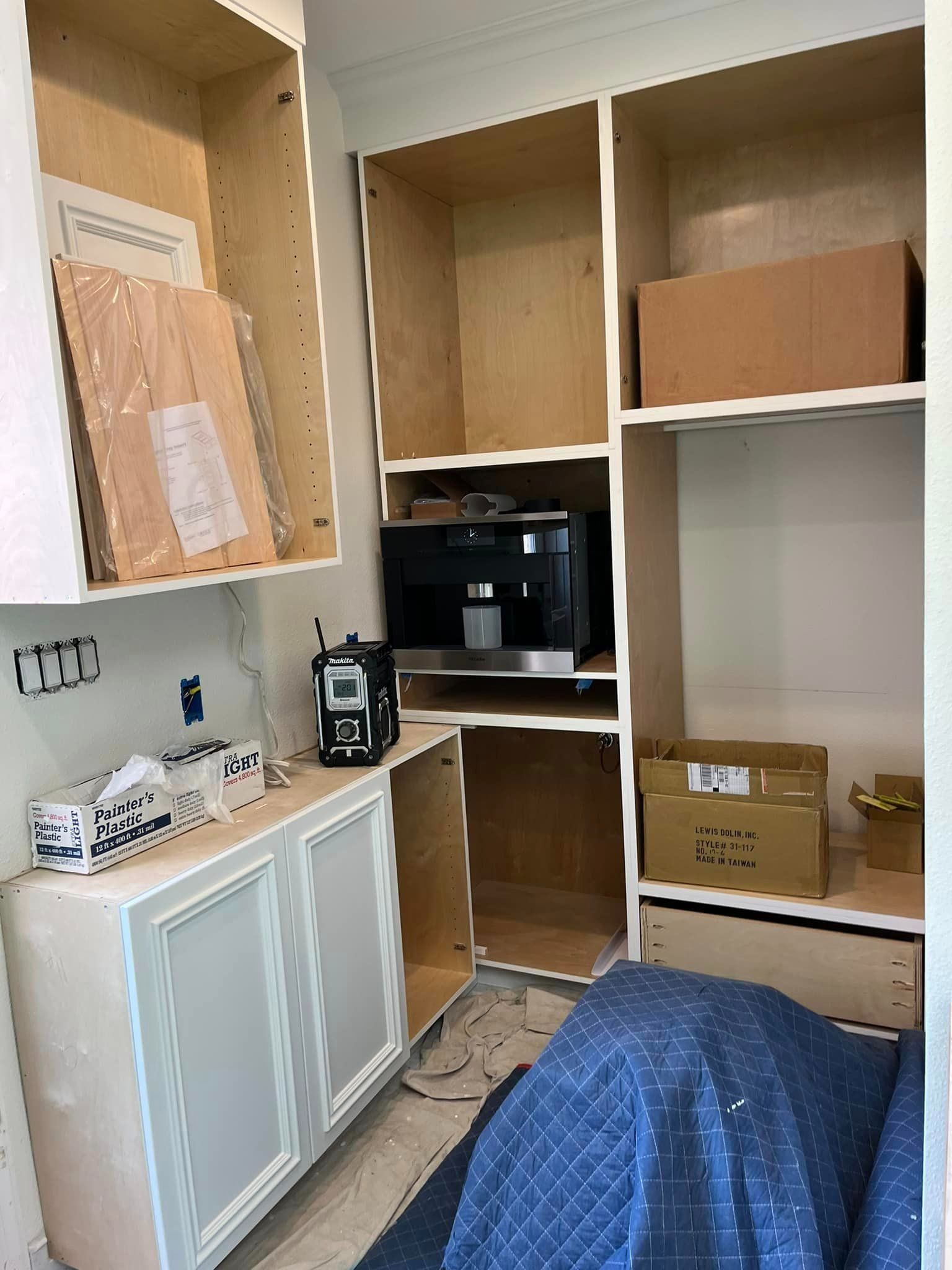 A kitchen with a microwave and a coffee maker in it.