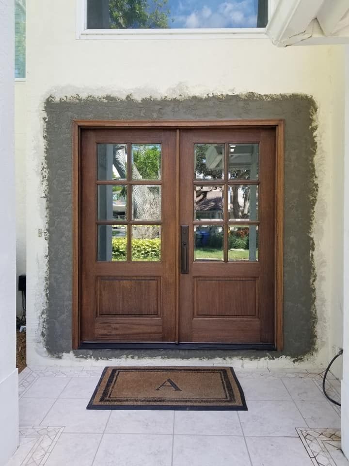 A wooden door with a mat in front of it