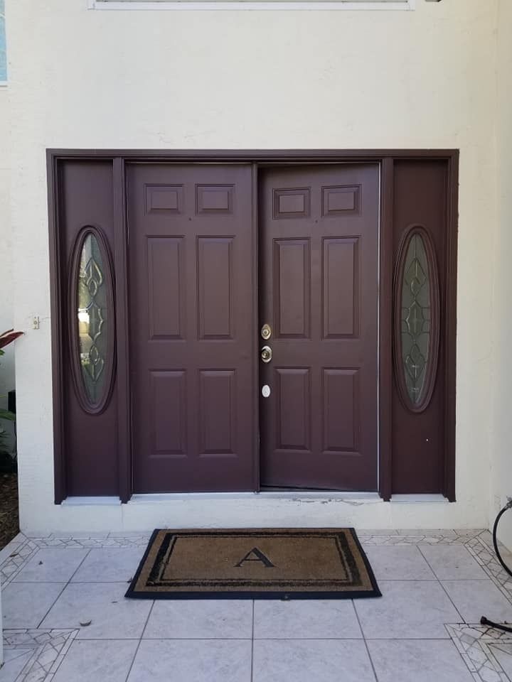 The front door of a house with a welcome mat in front of it.