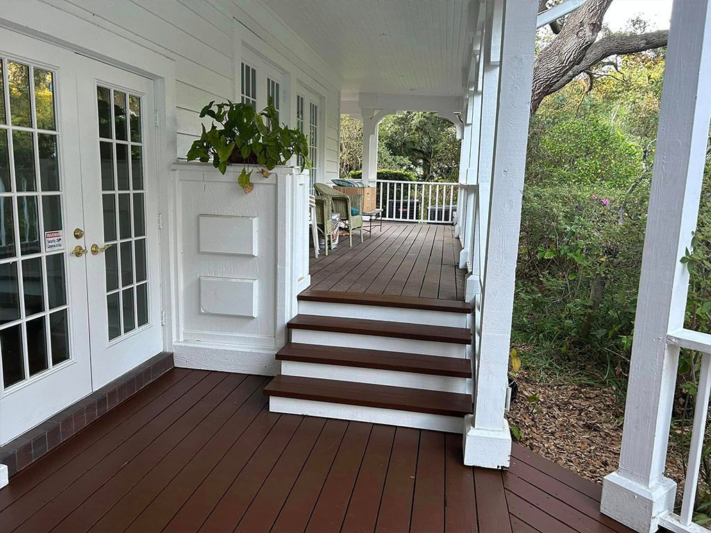 A large porch with stairs leading up to it.