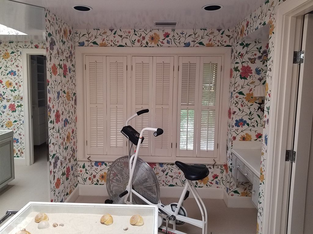 A room with a bicycle and a fan in it