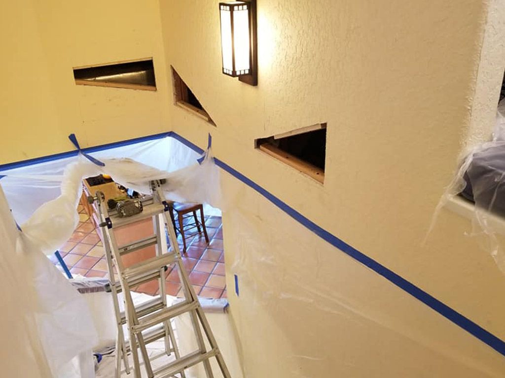 A ladder is sitting in the middle of a room.