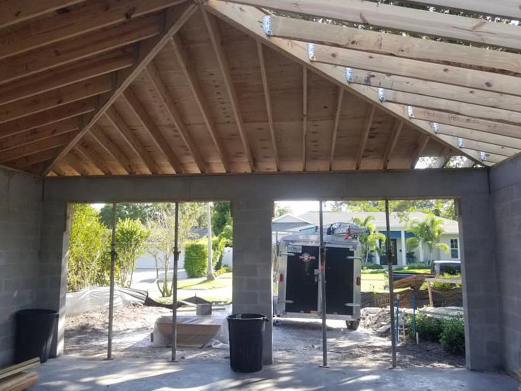 A kitchen with white cabinets and black counter tops