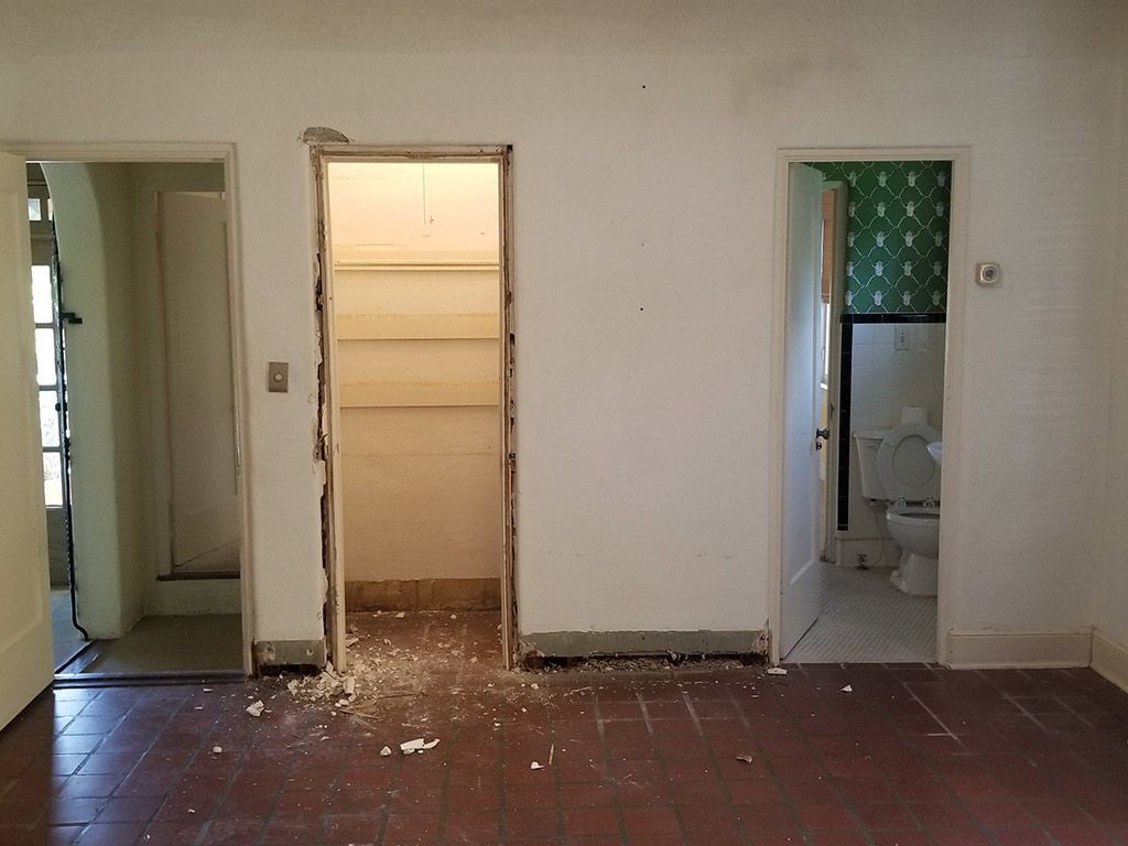 An empty room with a toilet and a closet