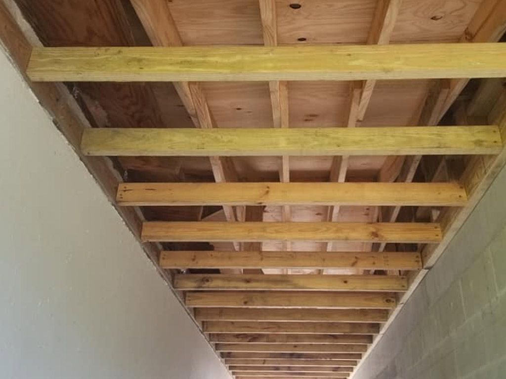 The ceiling of a building is being built with wooden beams.
