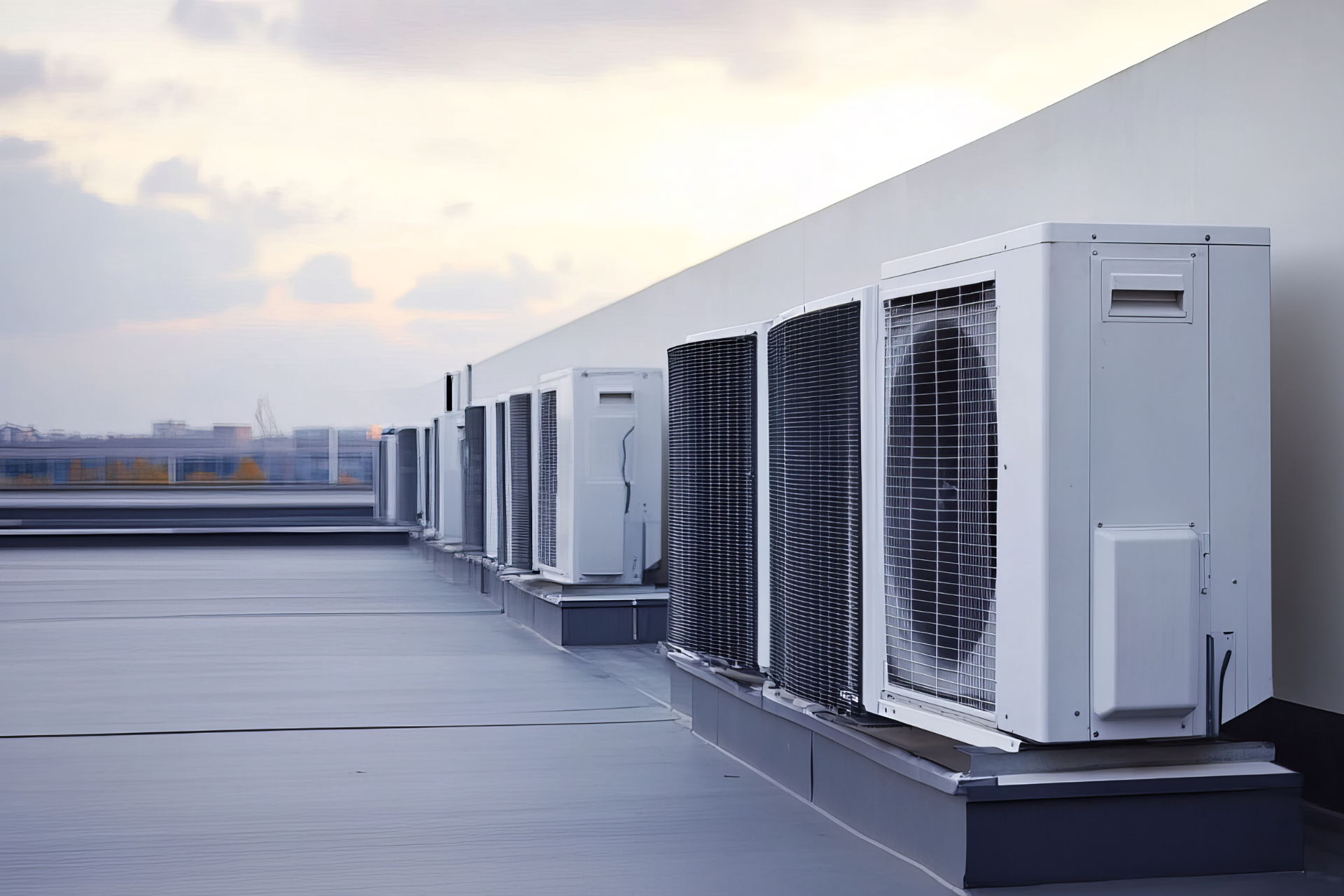 A row of air conditioners on the roof of a building.