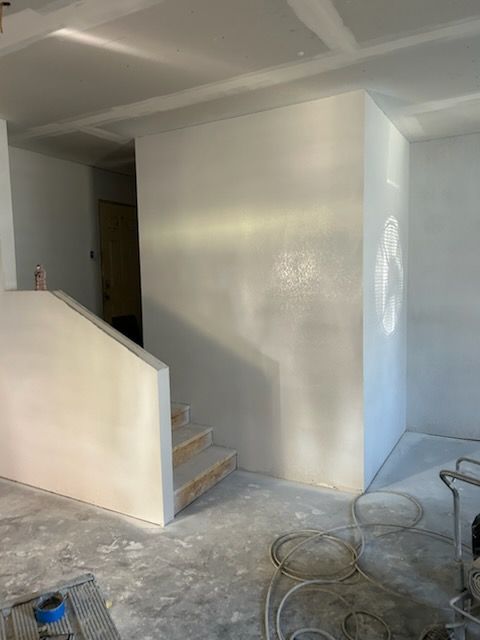 Before-and-after view of a doorway updated with a sliding barn door featuring three horizontal frosted glass panels.