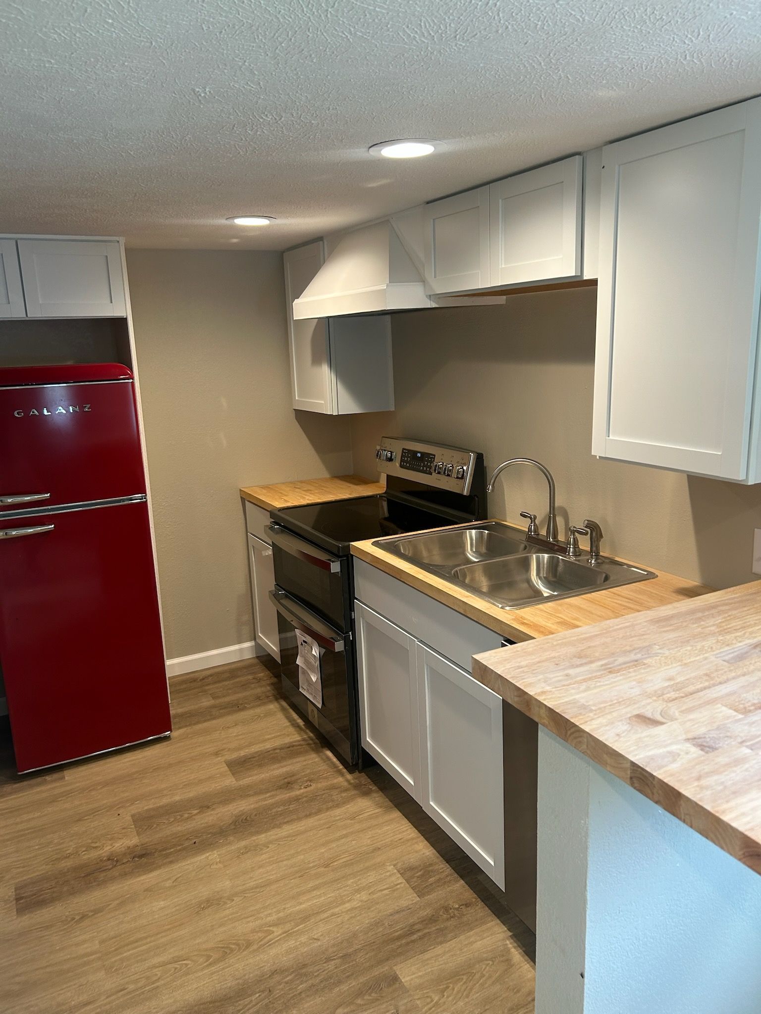 Before-and-after view of a doorway updated with a sliding barn door featuring three horizontal frosted glass panels.