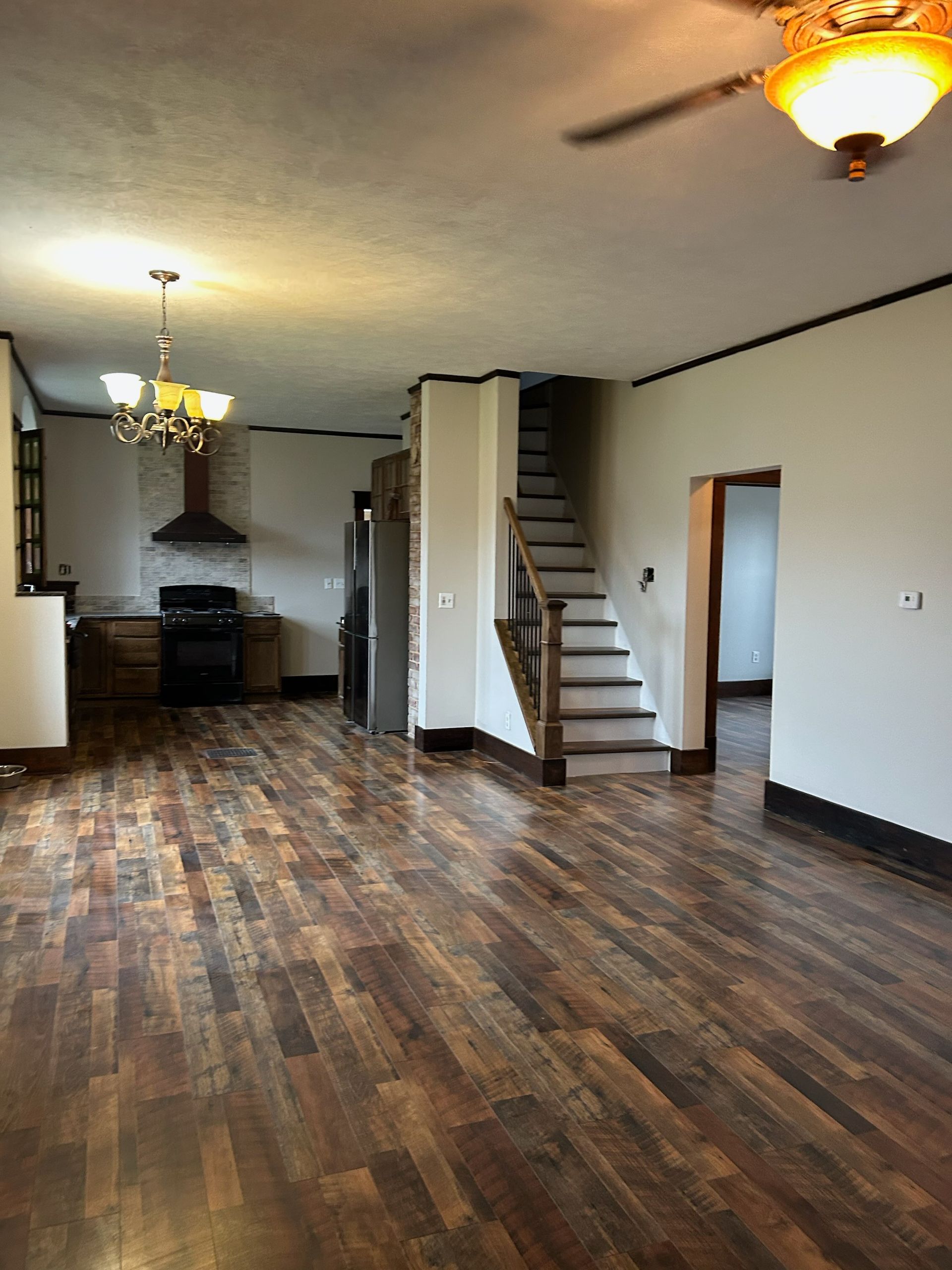 Three photos show a home renovation, including a finished room with wood floors and two views of construction debris.