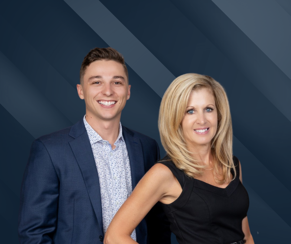 Young man and woman smiling, posed together; man in suit jacket, woman in black dress.