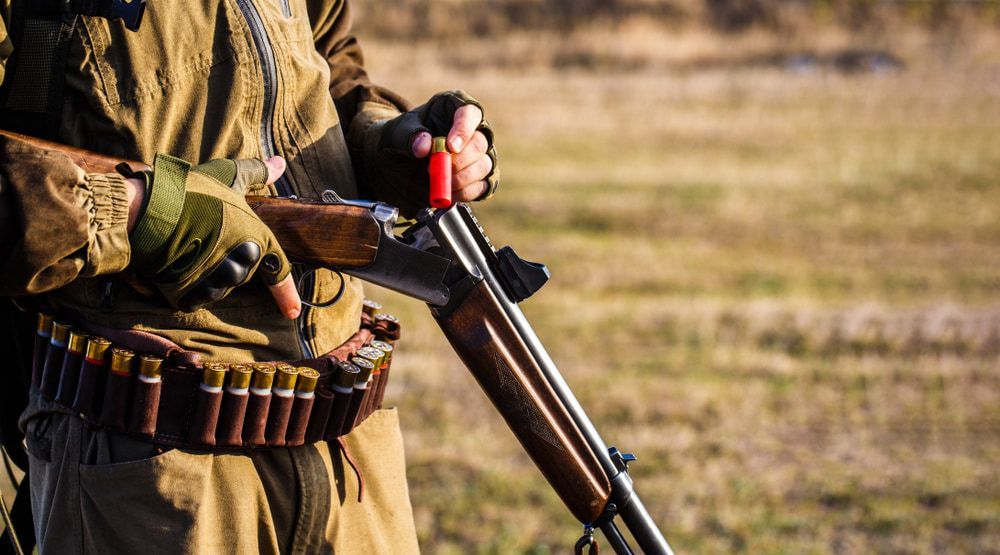 A Person Wearing a Brown Jacket Reloads a Double-barrel Shotgun — Mackay Shooters Supplies in Paget, QLD