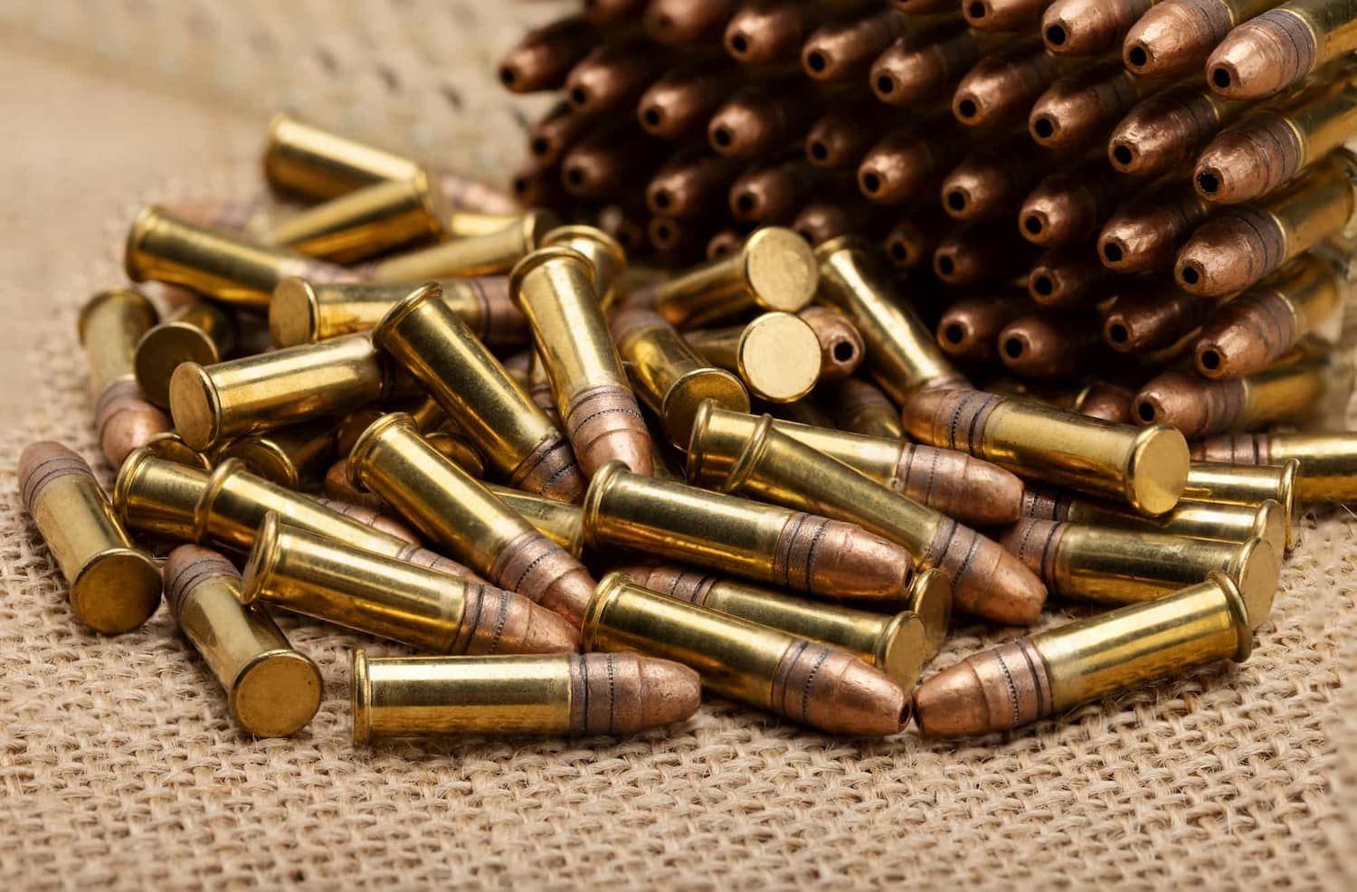 A Pile of Brass Bullets Sitting on Top of a Table — Mackay Shooters Supplies in Emerald, QLD