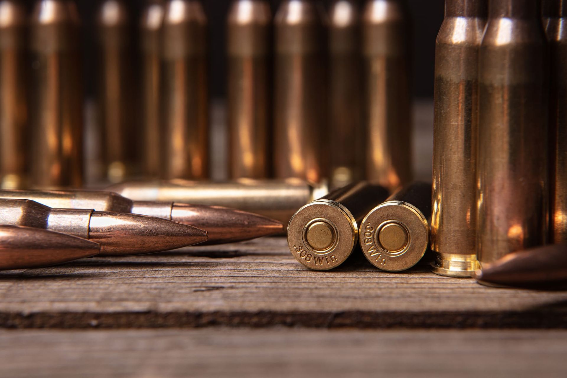 A Bunch of Bullets Are on a Wooden Table — Mackay Shooters Supplies in Mount Isa, QLD