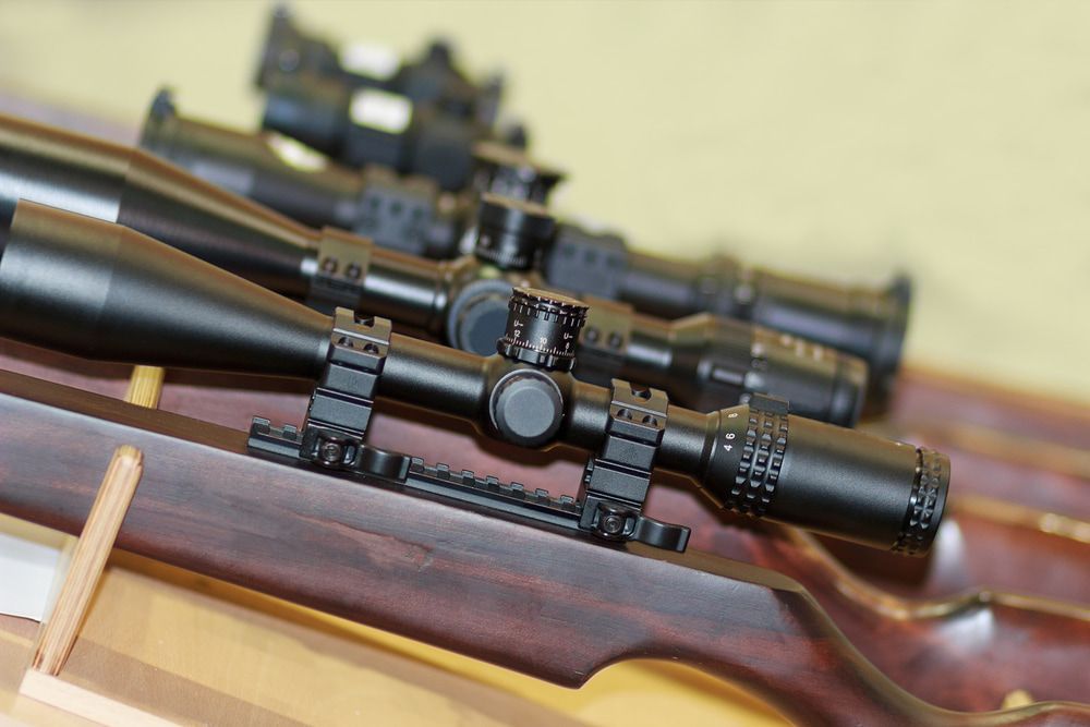 Close-up of Multiple Black Rifle Scopes on Wooden Gun — Mackay Shooters Supplies in Longreach, QLD