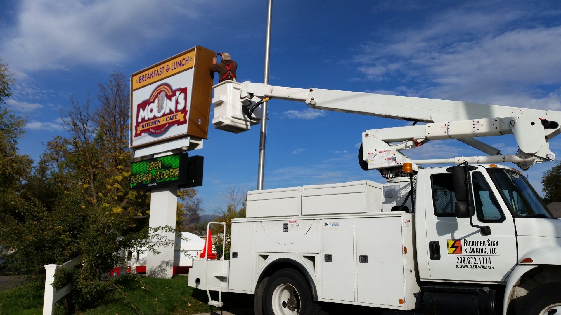 Worker on Bucket Truck Installing Signage