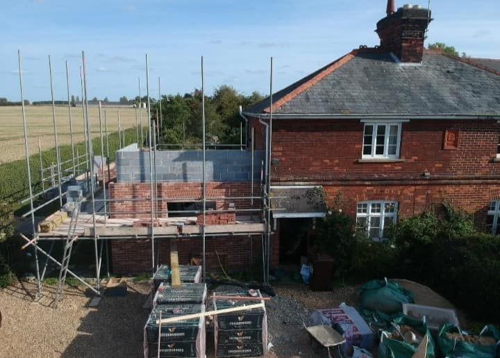 An aerial view of a house under construction with scaffolding around it, building work carried out by Pro Build East Ltd.
