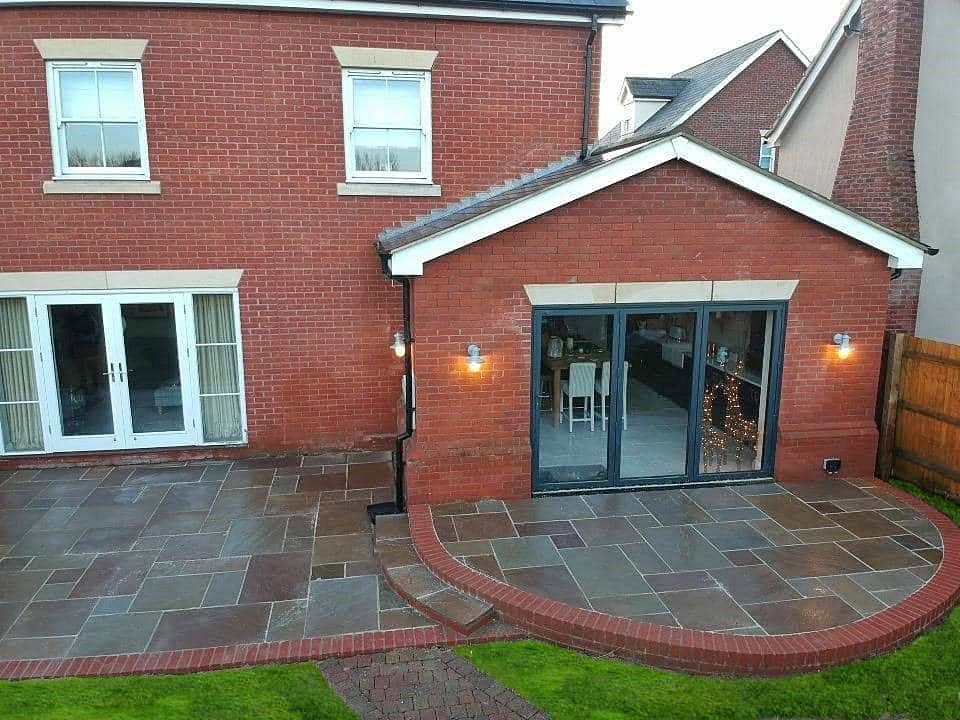 A beautiful rear single storey extension with a patio in front of it, built by Pro Build East Ltd.