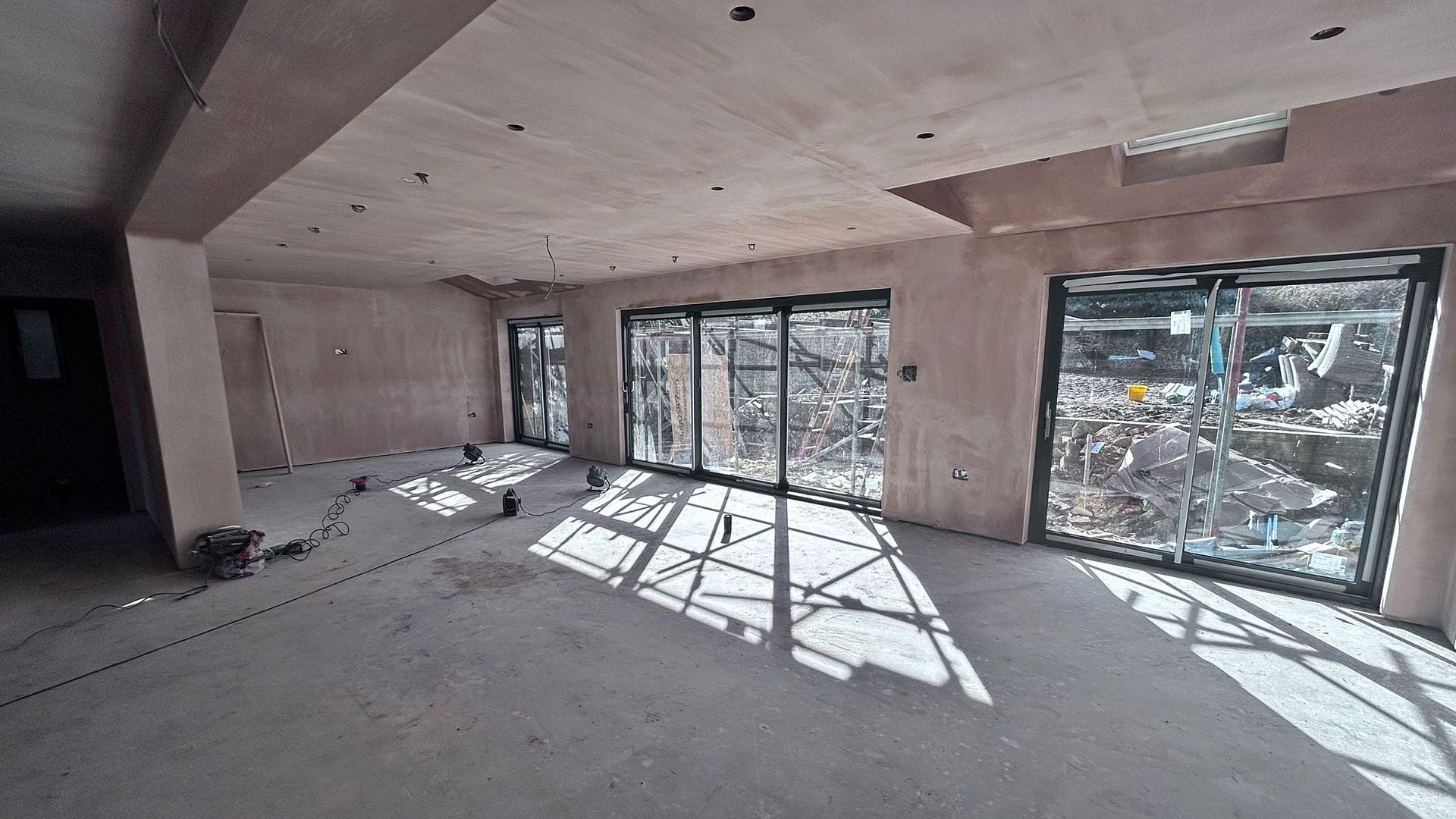 Pro Build East Ltd is best Hadleigh Builder and this is an example of liquid screed flooring over underfloor heating, plastered walls and patio and bi-fold doors.