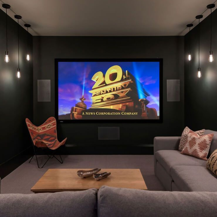 Best garage conversion in Suffolk by Pro Build East Ltd transformed into a modern home cinema with high-quality finishes and immersive lighting