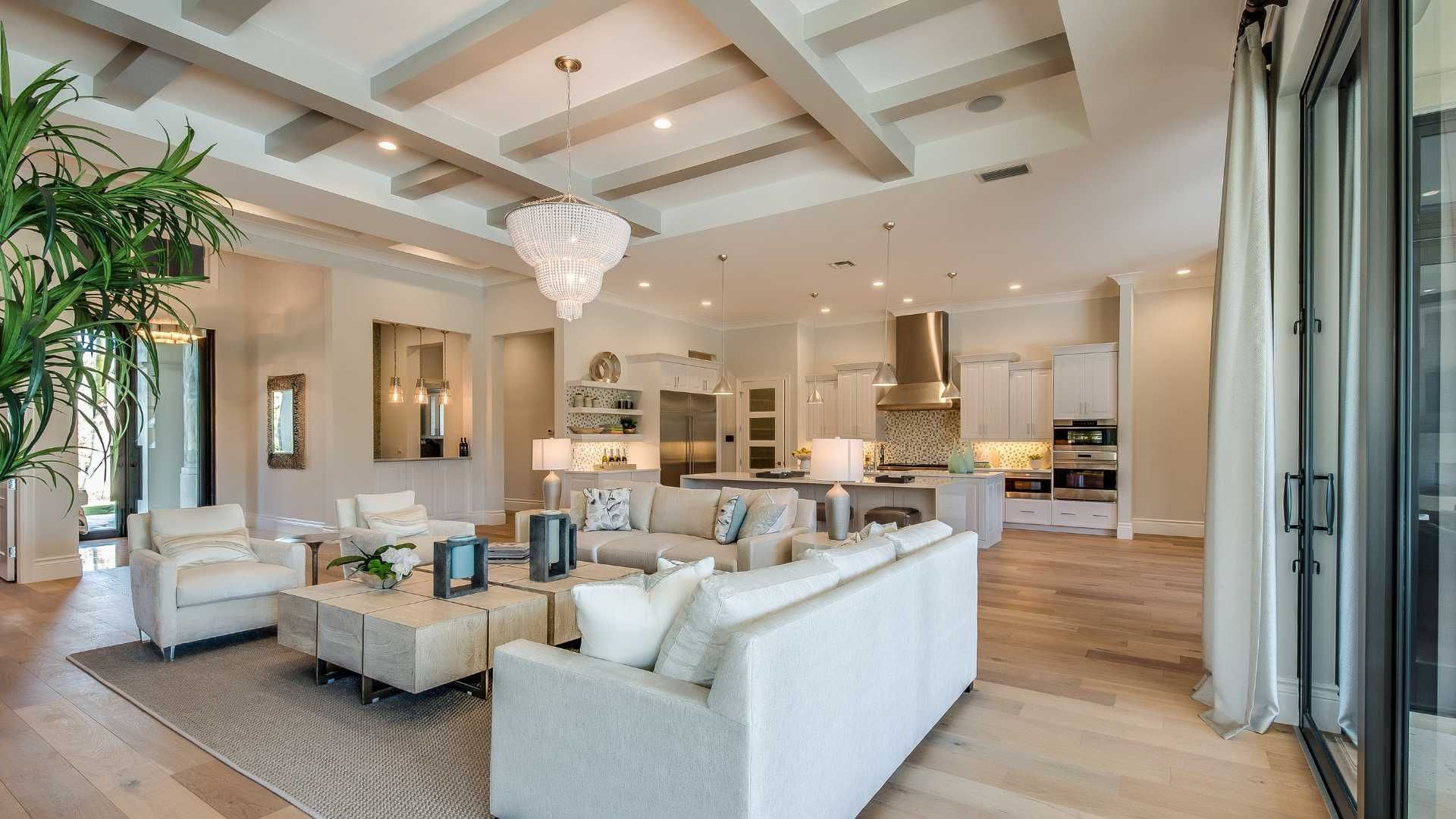 A living room with a couch , table , chairs and a laptop on the table.