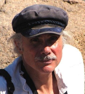 A man wearing a hat and a white shirt