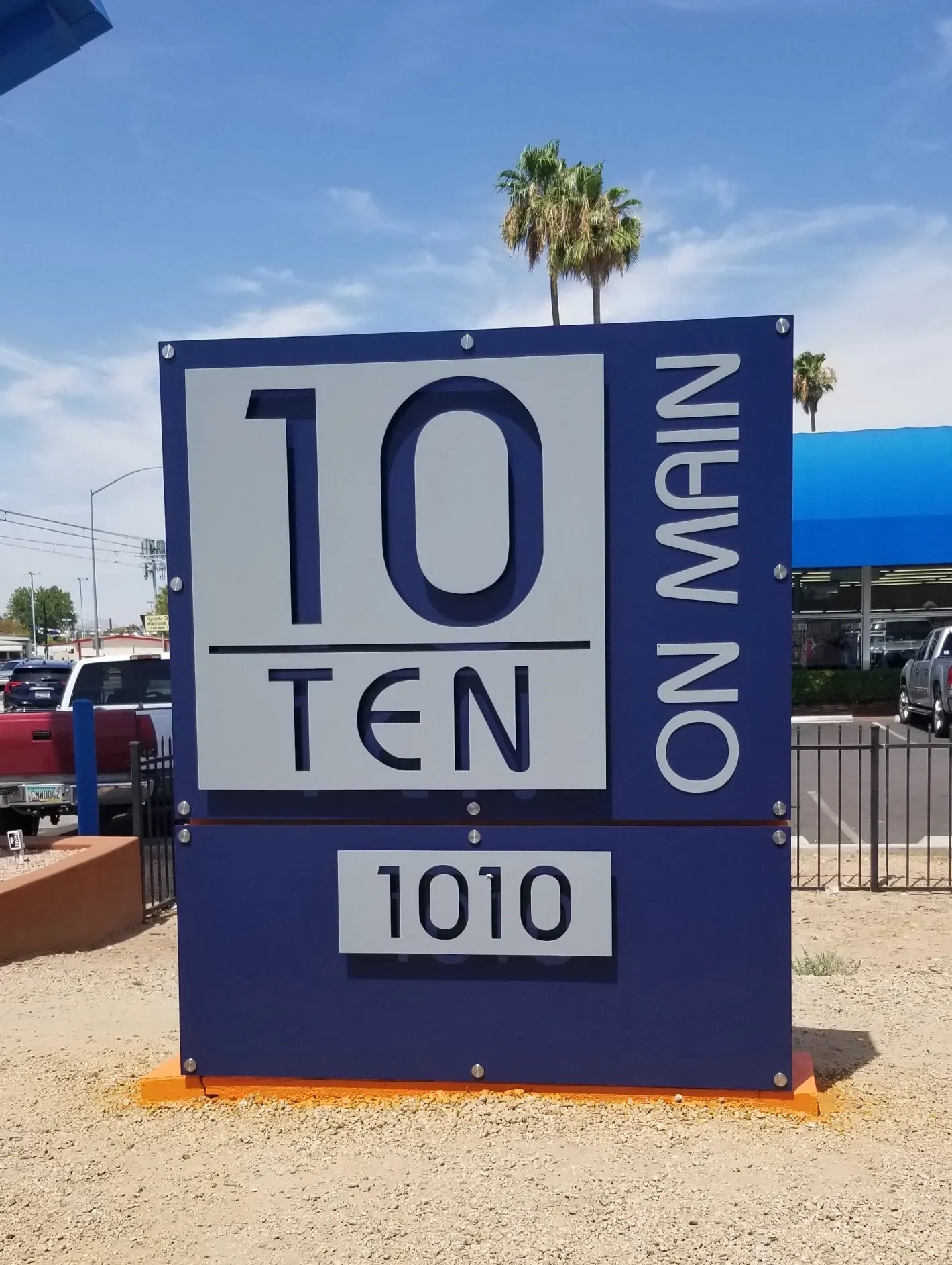 A blue and white sign that says 10 ten on main 1010