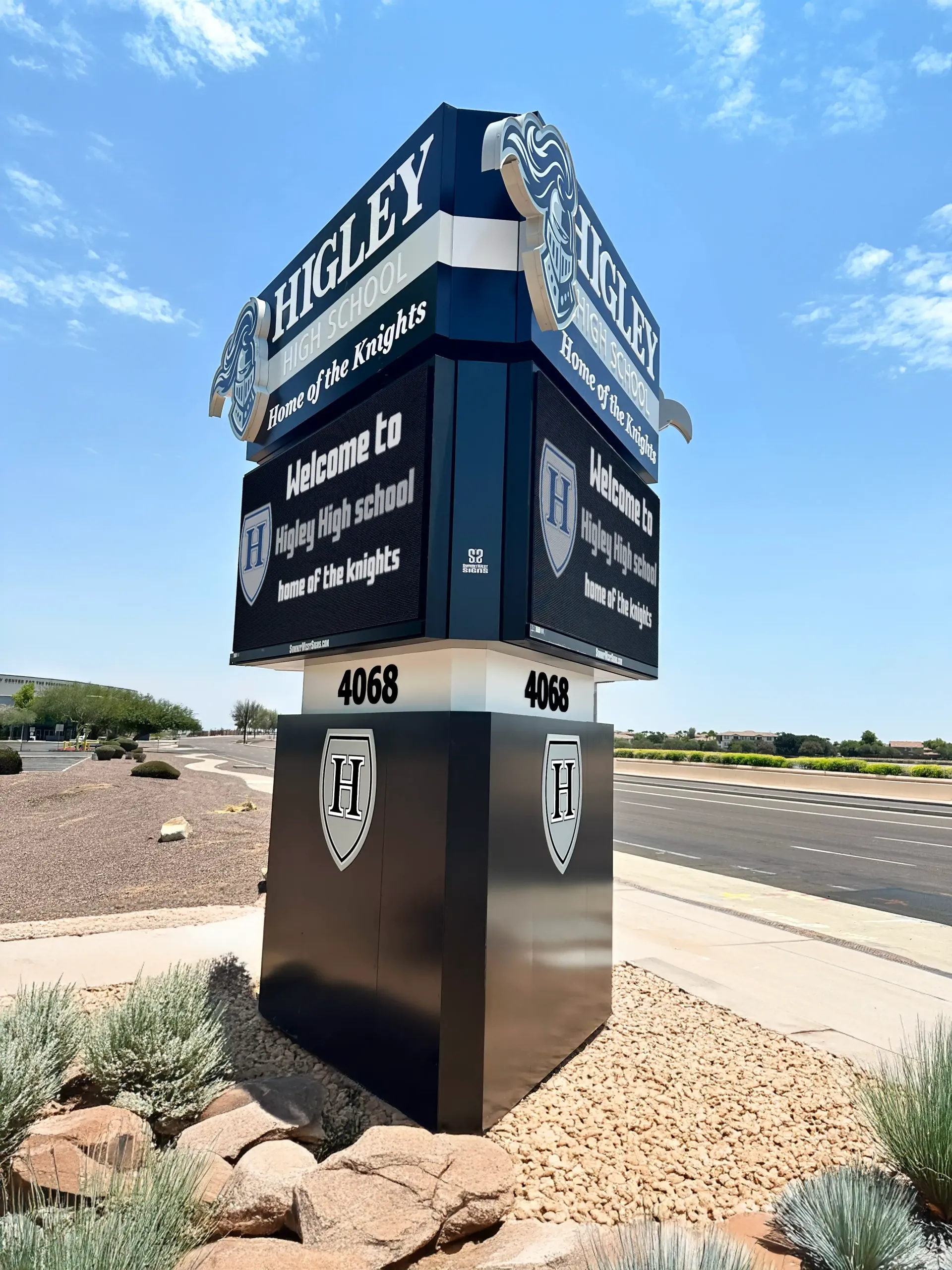A large sign that says harley is sitting on the side of a road.