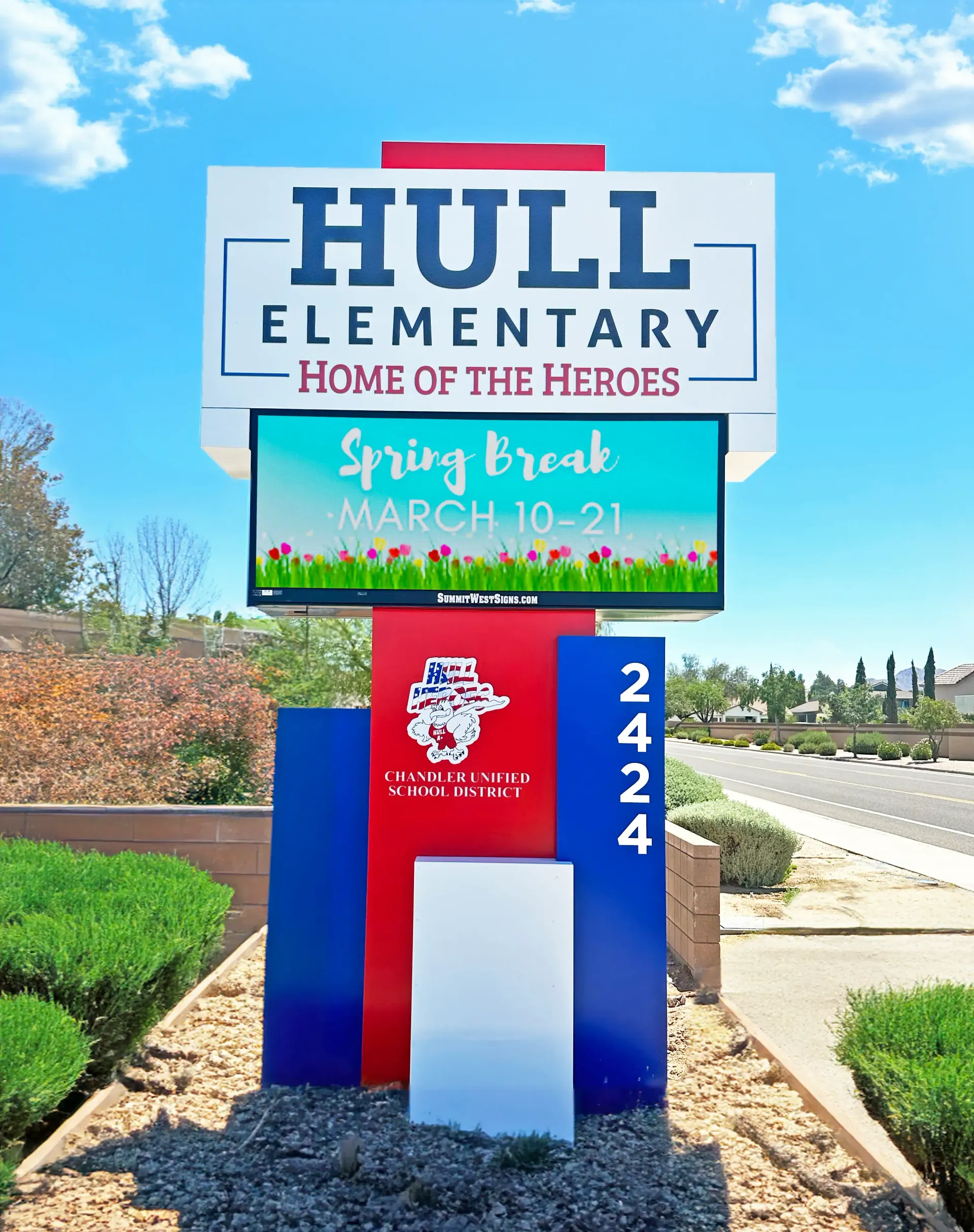 A sign for hull elementary school is sitting on the side of the road.