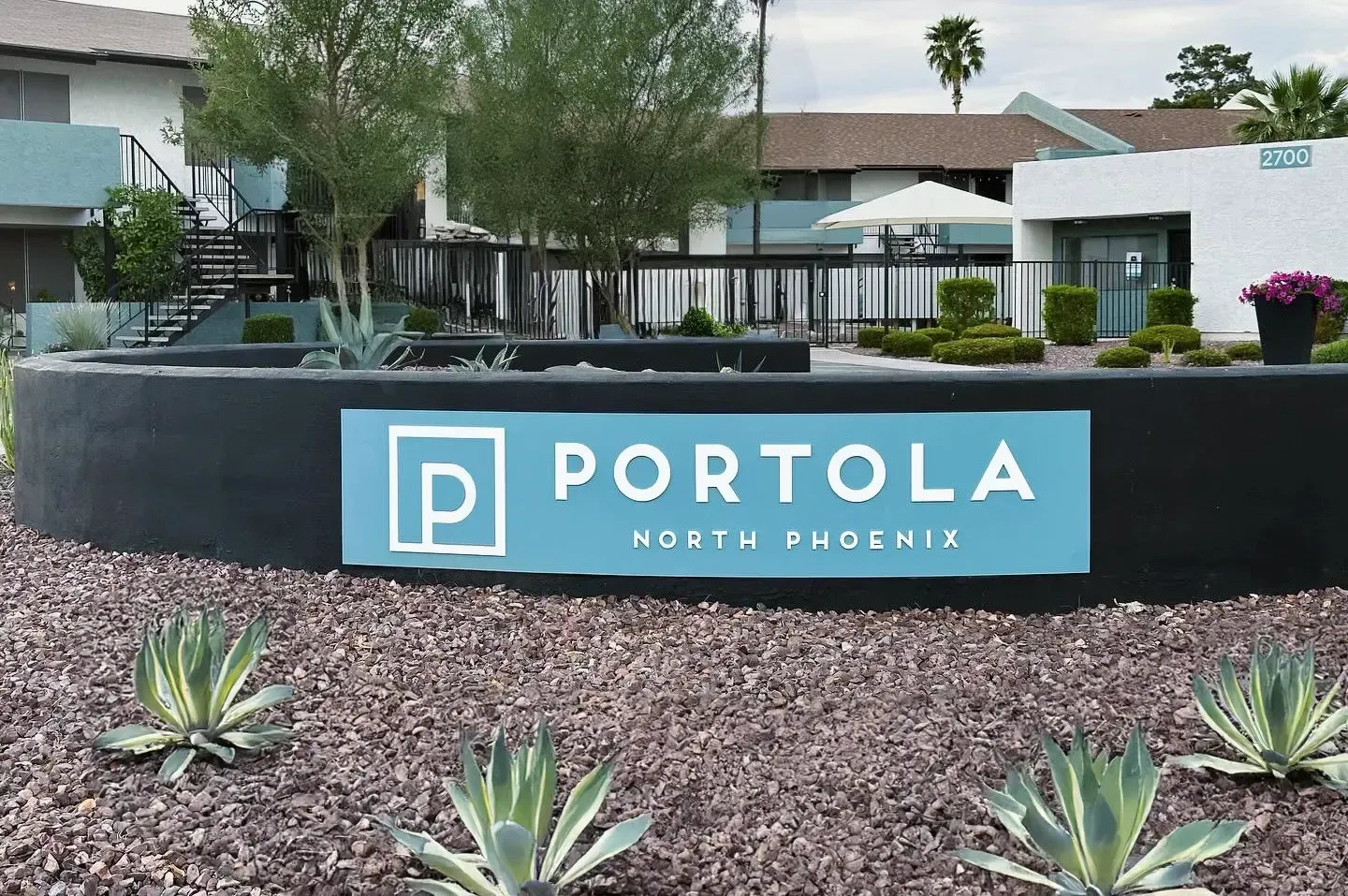 A sign for portola is in front of a building