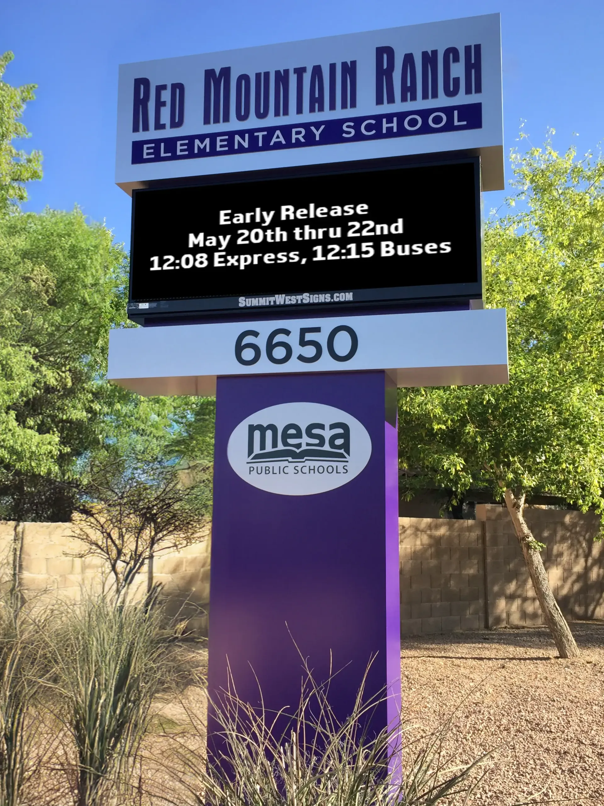 A purple and white sign for red mountain ranch elementary school