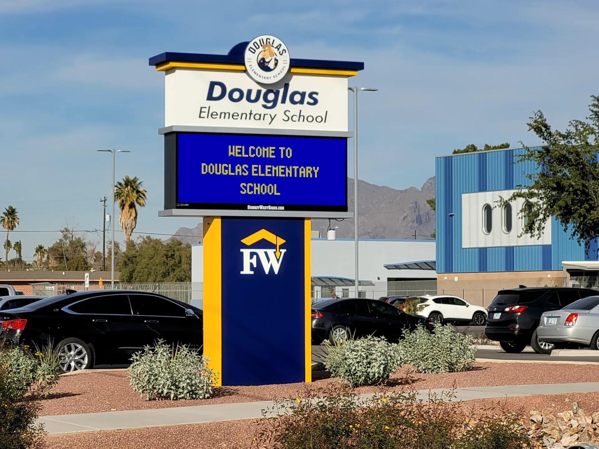 A blue and yellow sign for douglas elementary school