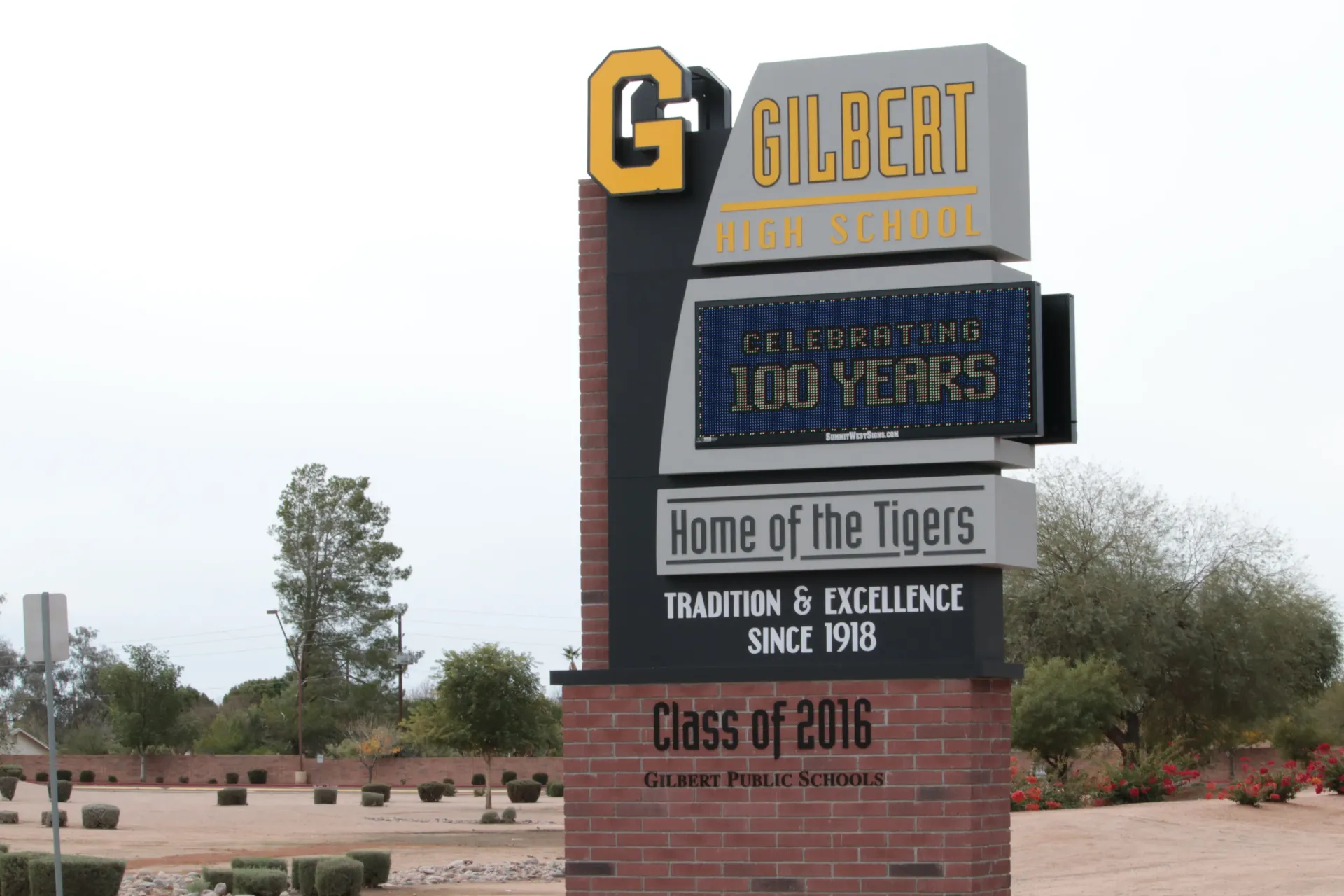 A sign for gilbert high school says home of the tigers