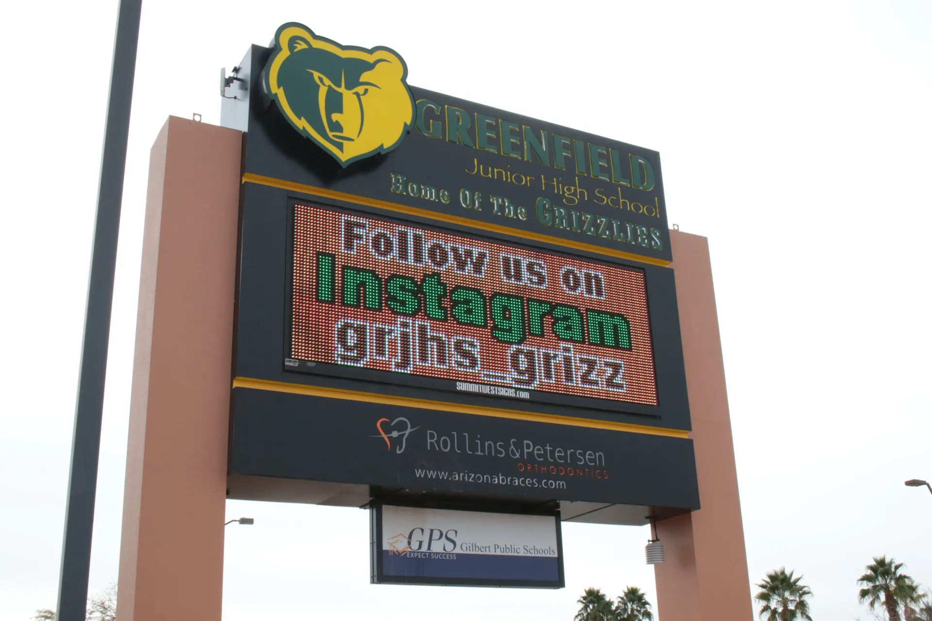 A sign for a school with a bear on it