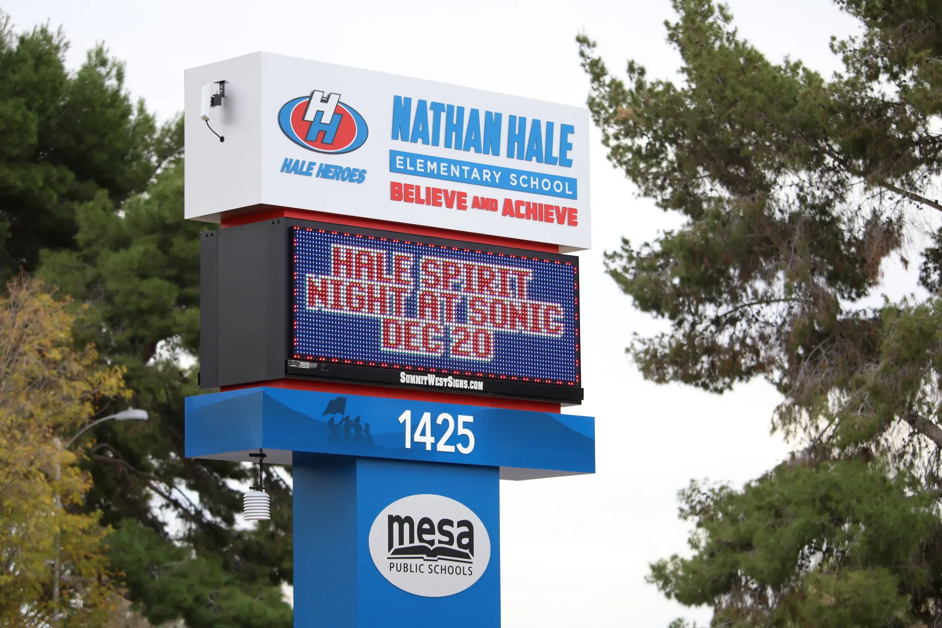A blue and white sign for nathan hale elementary school