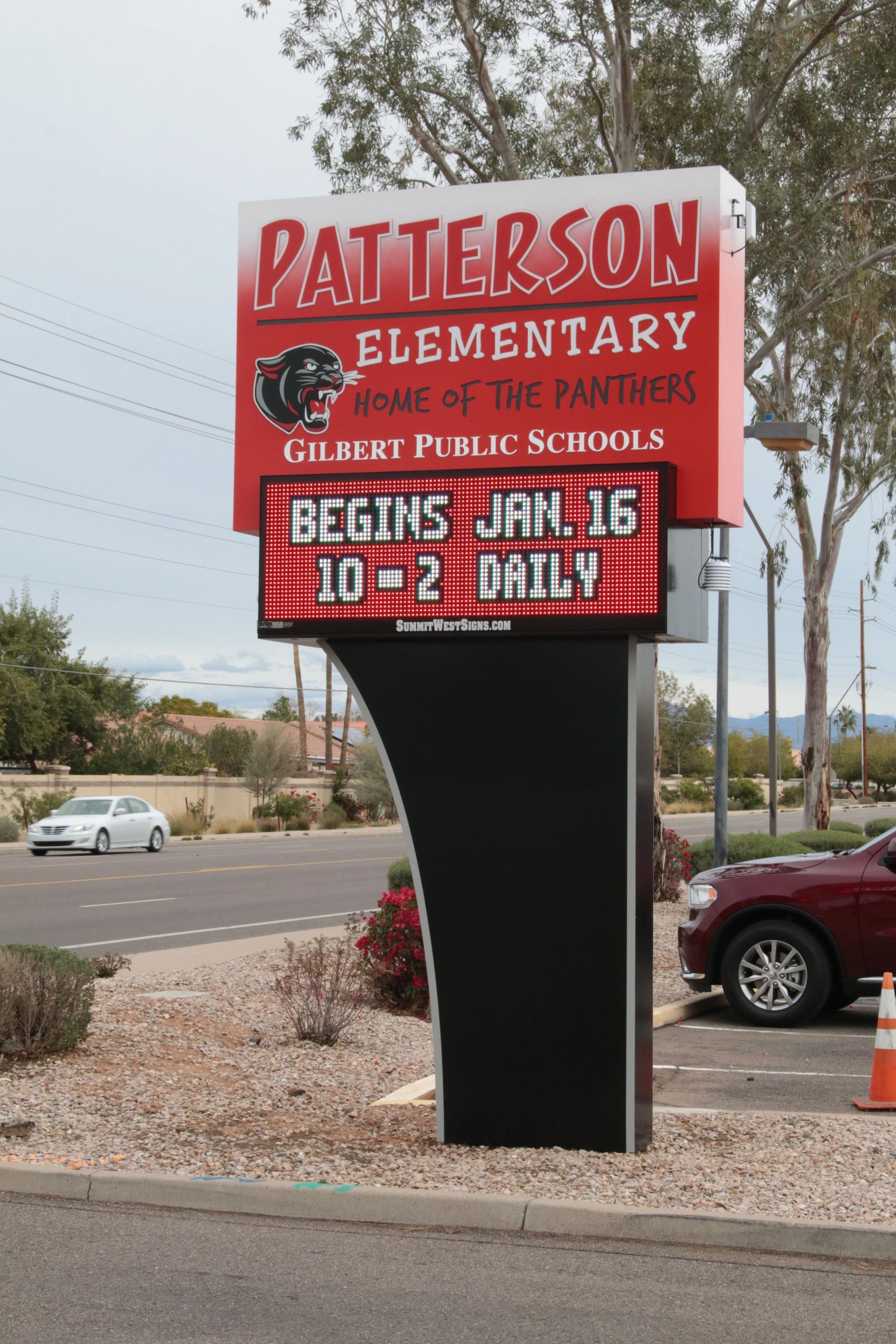 A sign for patterson elementary school is displayed in a parking lot