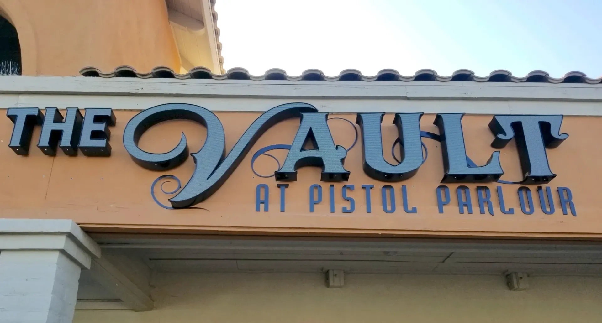 A sign for the vault at pistol parlour