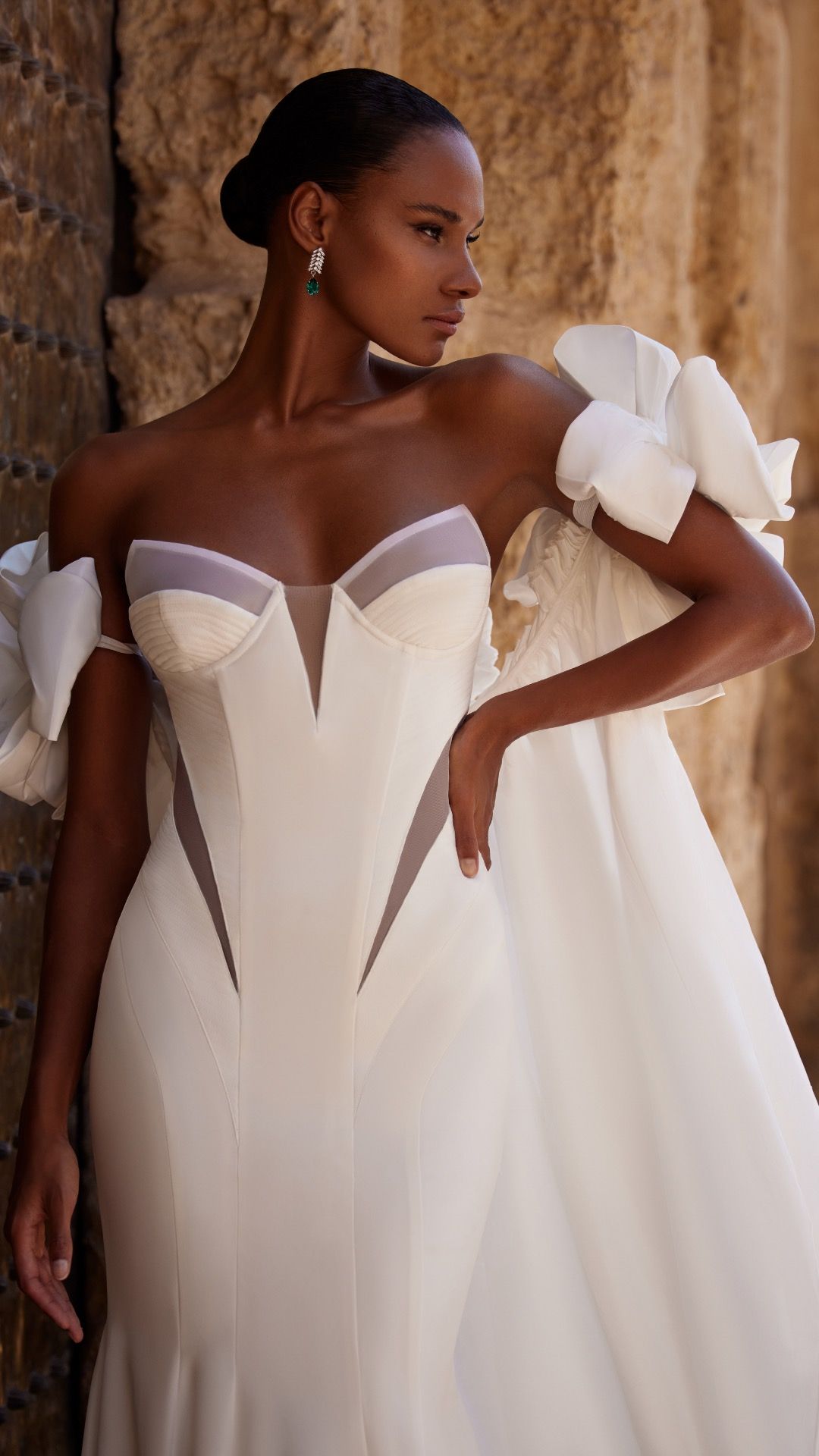 Three people in embellished wedding gowns. Black and white.