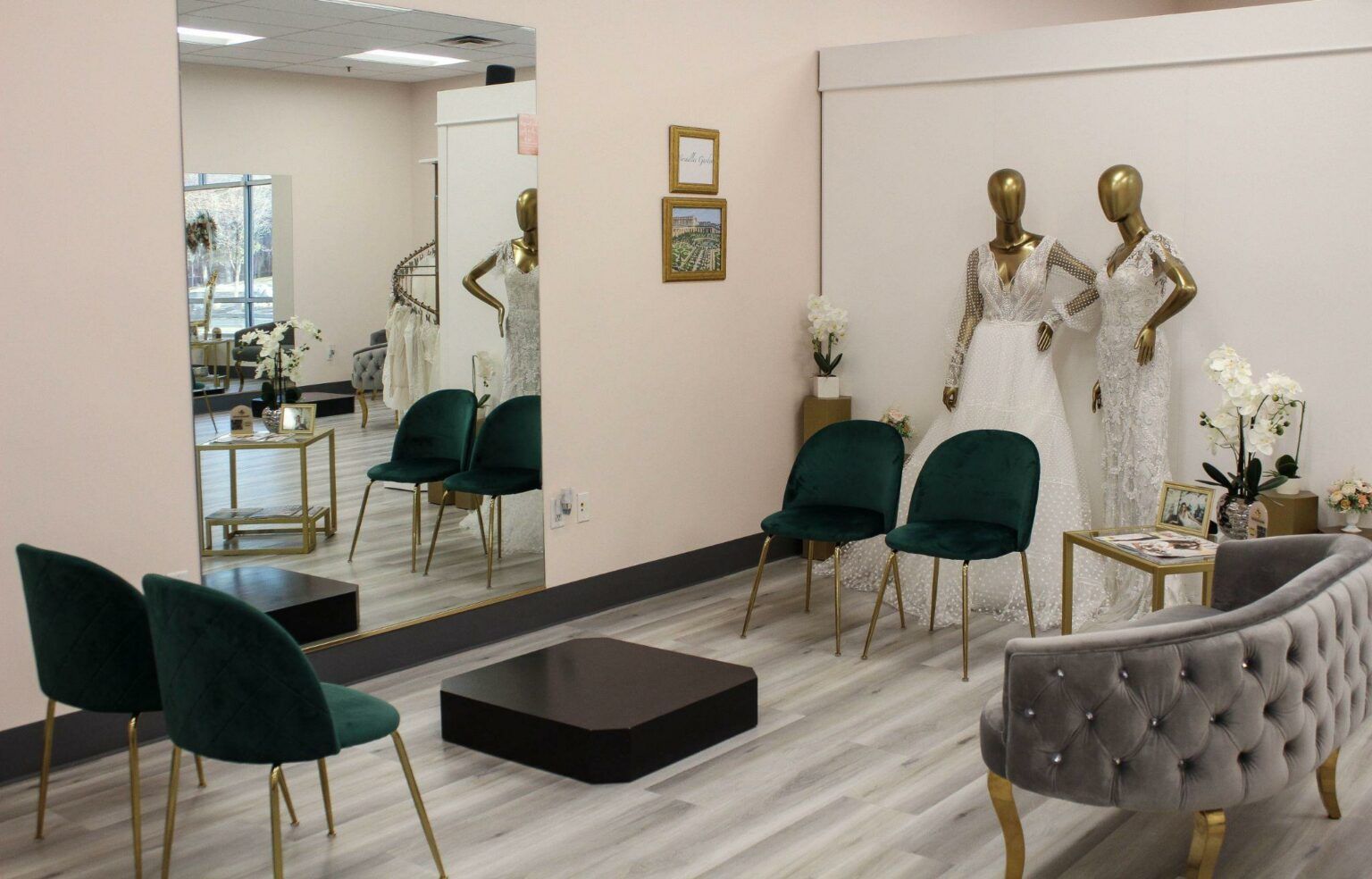 A room with a couch , chairs , a table and a mirror.