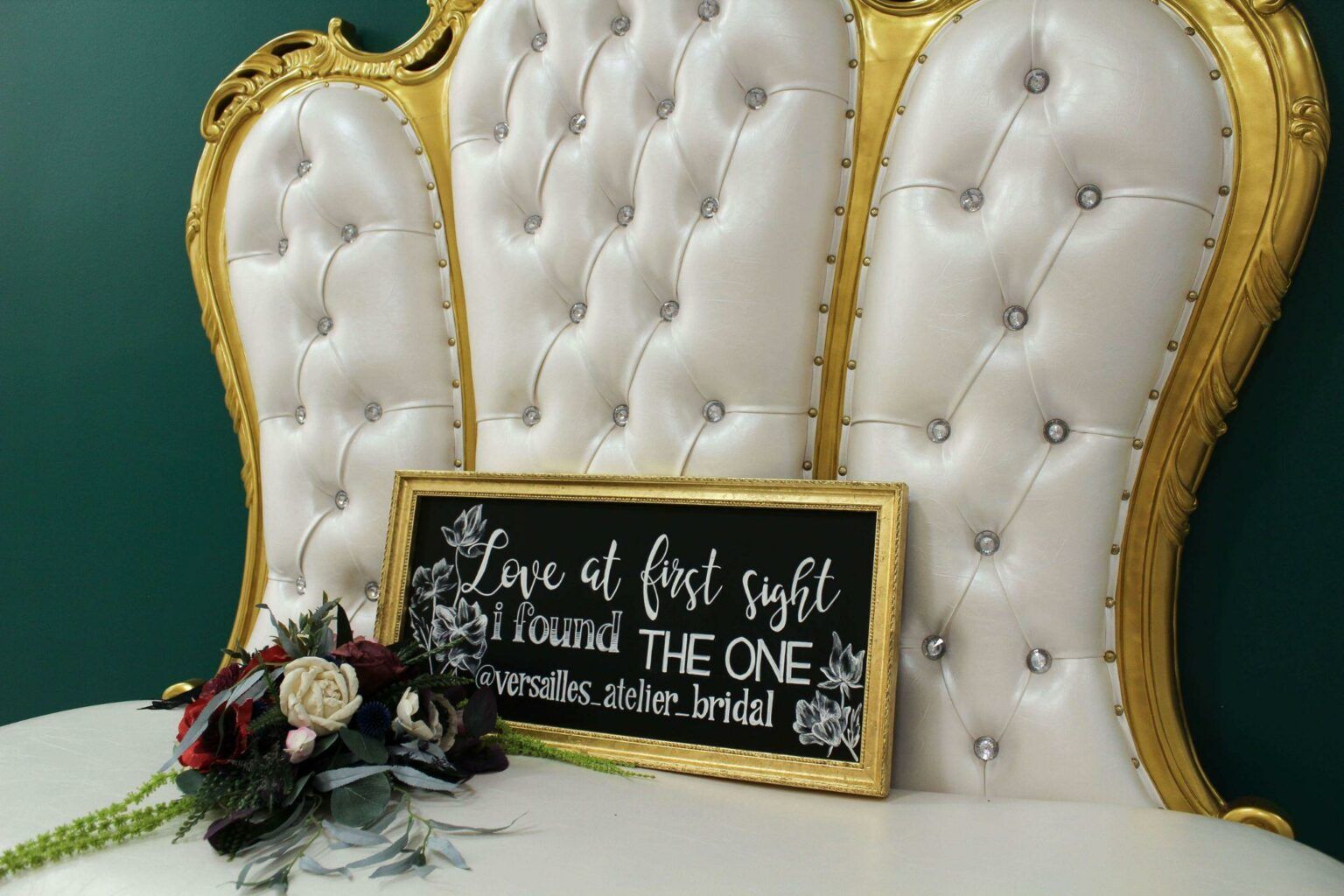 A white and gold headboard with a sign on it that says `` love at first sight found the one ''.